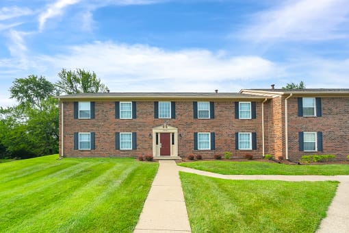 Exterior view of Carriage House Apartments in New Albany, showcasing the building's architecture and surrounding landscape.