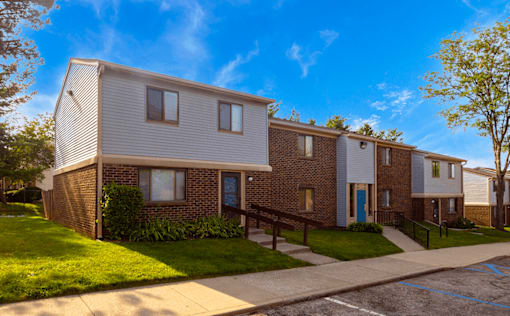 Exterior view of Henderson Court Apartments showcasing architecture and well-maintained surroundings.