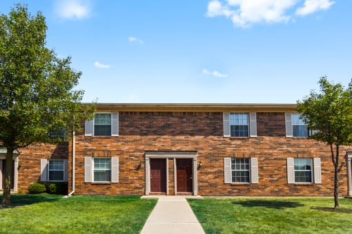 Exterior of Richfield Apartments in Fort Wayne, featuring lush landscaping, and a welcoming entrance.