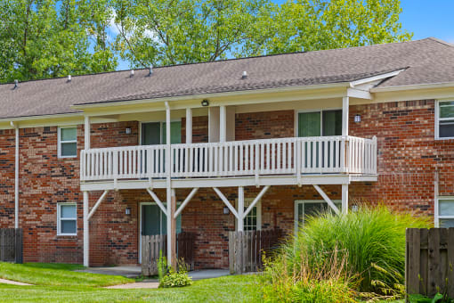 Exterior view of Hampton Court Apartments, featuring balconies and patios.