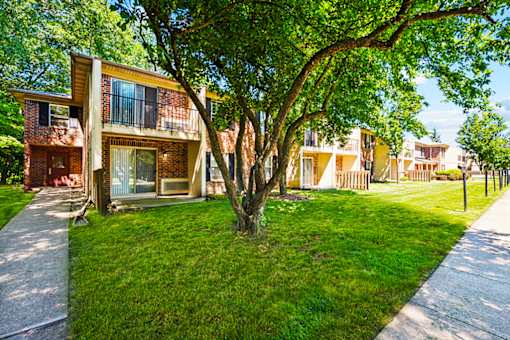 Exterior view of Fairington Apartments building showing balconies and patios with landscaping in South Bend.