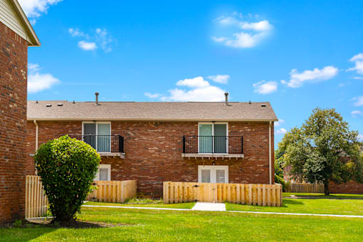 Exterior view of Bradford Lake Apartments with balcony and patio.