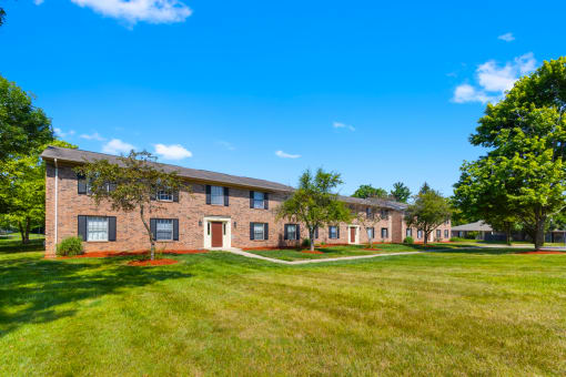 Exterior view of Cambridge Square Apartments in Greenwood, with well-maintained landscaping, and a welcoming entrance.