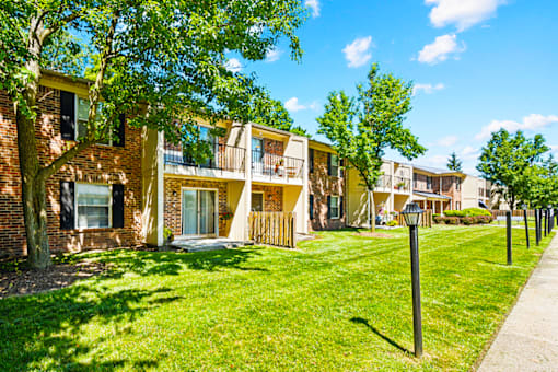Exterior view of Fairington Apartments building in South Bend with landscaped grounds.