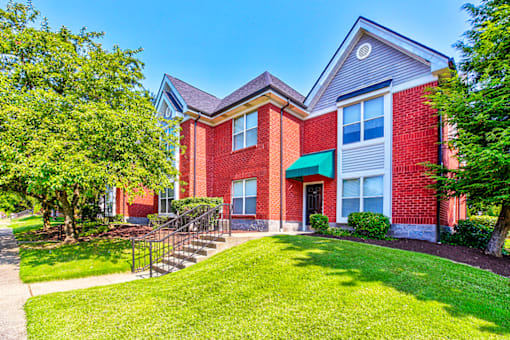Exterior view of the building at Hampton Place Apartments, showcasing architecture and well-maintained landscaping.
