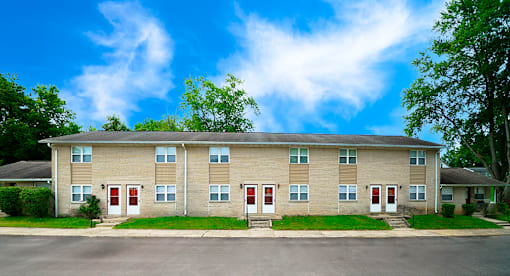 Apartment building with red doors and windows.