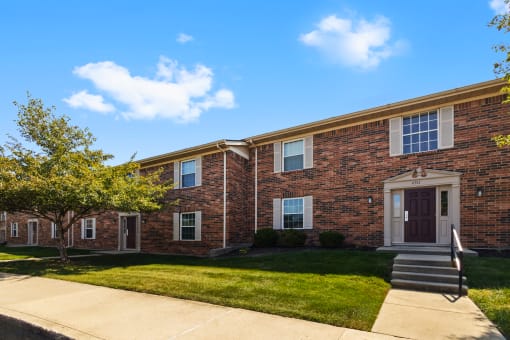 Exterior of Richfield Apartments in Fort Wayne, featuring lush landscaping, and a welcoming entrance.