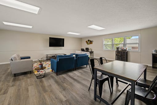 Business center at Country View Apartments, featuring comfortable seating, a TV and a workstation.