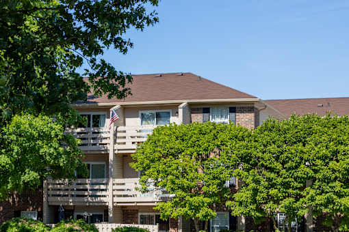A building with a balcony and an American flag.