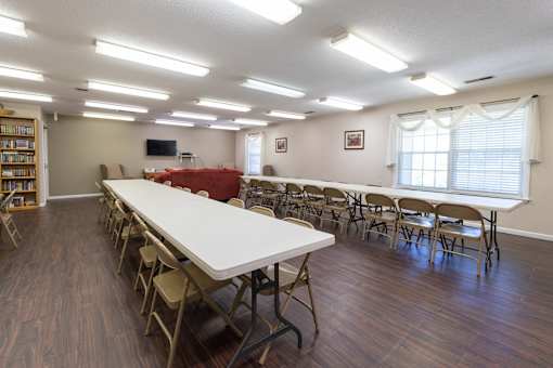 A room with a long table and chairs is set up for a meeting or event.