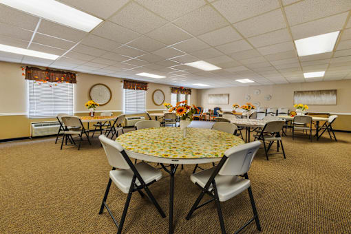 Interior of the Edsall House clubhouse dining room, showcasing tables and chairs.