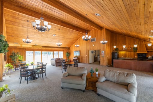 Clubhouse with a full kitchen and an entertainment area with ample seating at Woodbridge Apartments