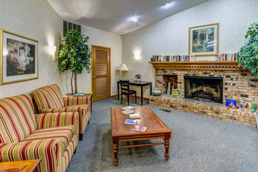 Cozy clubhouse interior with a fireplace at Cedar Ridge Apartments