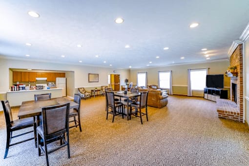 Clubhouse at Jamestown Valparaiso, featuring cozy seating area with comfortable couches and chairs, and large windows that let in natural light.