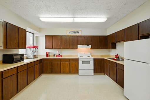 Clubhouse kitchen at Hammond Elderly Apartments with appliances and counter space.