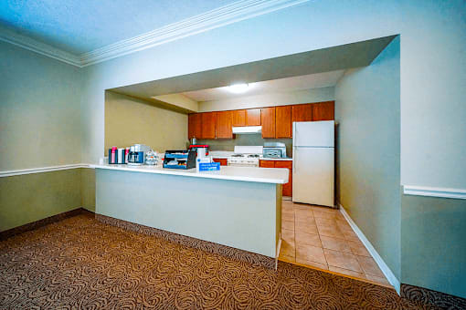 Clubhouse kitchen at Jamestown Valparaiso, featuring appliances and ample counter space.