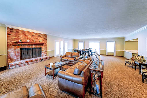 Clubhouse lounge at Jamestown Valparaiso, featuring cozy seating area with comfortable couches and chairs, and large windows that let in natural light.