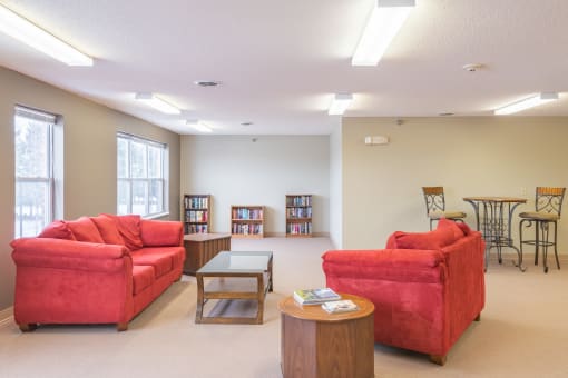 Community room with a library at Kirby Manor