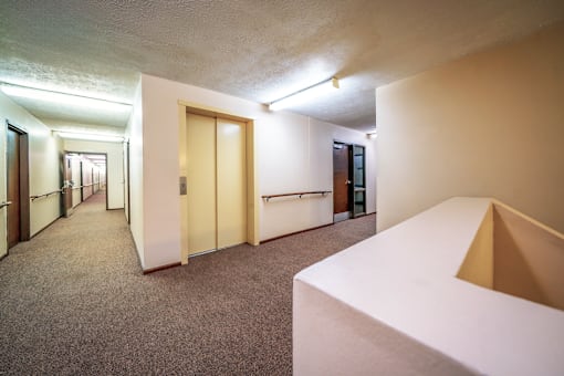 A hallway with an elevator at Wesley Park Apartments, providing convenient access to all floors.