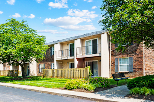 Exterior view of a balcony and patio area at Blairwood Apartments in Louisville, surrounded by landscaped greenery.