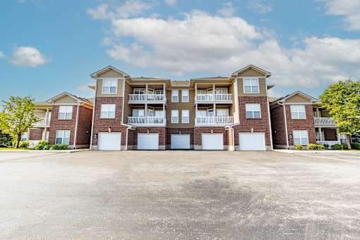A large apartment complex with multiple balconies and garage doors.