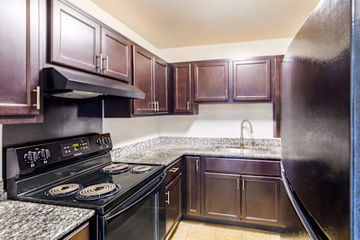 Kitchen in a 2-bed, 1-bath apartment at Cambridge Square Apartments in Lauderdale Lakes, featuring kitchen appliances, ample cabinetry, and a functional layout.