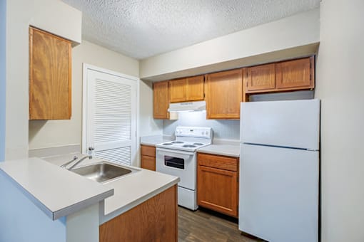 Kitchen in a 2-bedroom, 1-bathroom apartment at Hampton Place Apartments, featuring appliances, counter space, and cabinets.