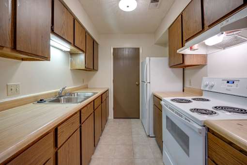 Kitchen with all white appliances and ample cabinets in a 2 bedroom apartment at Regency Park Apartments