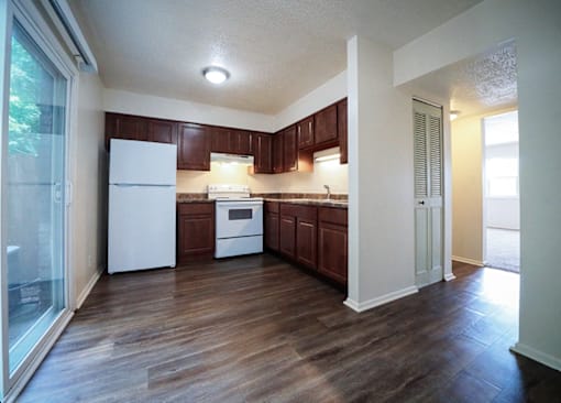 Kitchen in a 2-bedroom townhome at Rainbow Hills Apartments with kitchen appliances and cabinets.