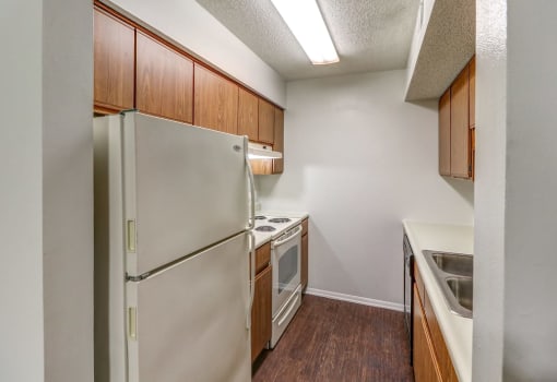 Kitchen with white appliances and lots of cabinets at Ashley Pointe Apartments