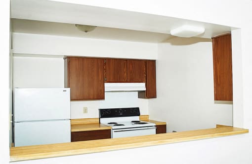 Spacious kitchen with all white appliances and breakfast bar.