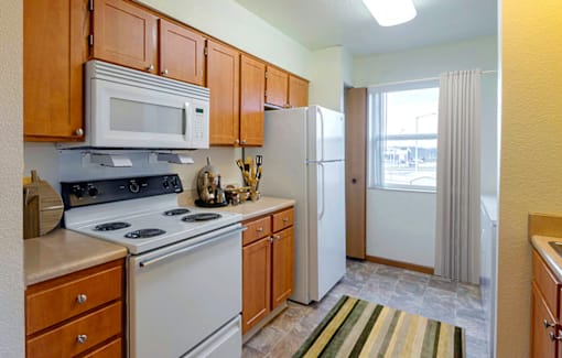 Kitchen with a stove, microwave, and refrigerator  at Copper Gate, Lafayette, 47909