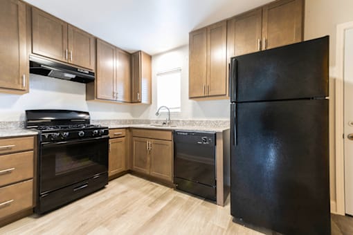 Kitchen with wood cabinetry, and appliances in Northwood on the Trail.