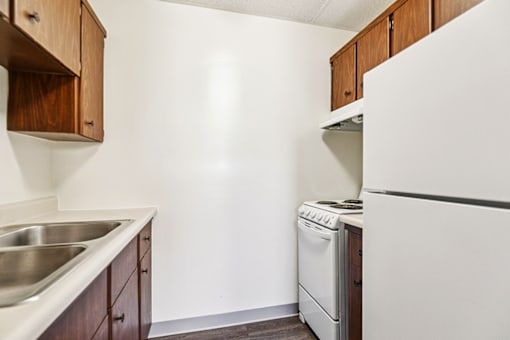 Kitchen in a one-bedroom apartment at Fowler in Lafayette, IN, with appliances and cabinets.