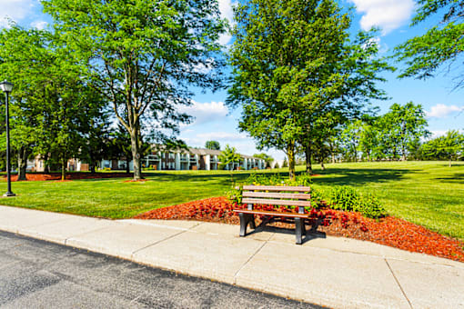 Landscaped grounds with outdoor seating at Fairington Apartments, Fort Wayne.