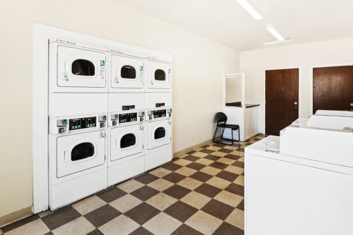 Laundry facility at Richfield Apartments in Fort Wayne, showcasing washing machines and dryers in a tidy, well-lit area for residents' convenience.