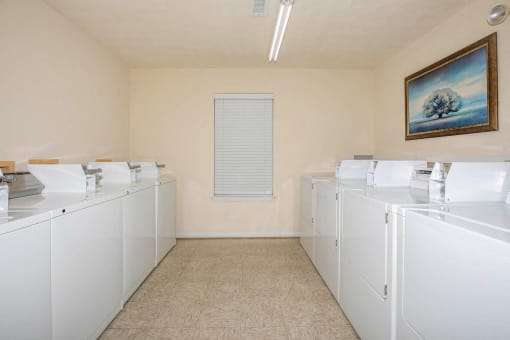 Apartment community amenity laundry facility with washers and dryers at King’s Landing Apartments