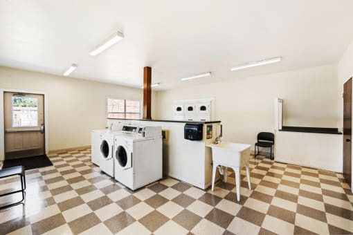 Laundry facility at Richfield Apartments in Fort Wayne, showcasing washing machines and dryers in a tidy, well-lit area for residents' convenience.
