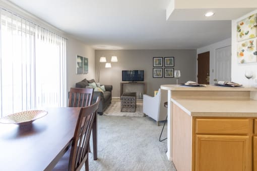 Open Living and Dining Room with Patio Access in a One Bedroom Apartment  at Ashmore Trace