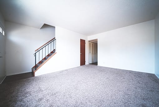 Living room in a 2-bedroom townhome at Rainbow Hills Apartments with spacious layout and natural light.