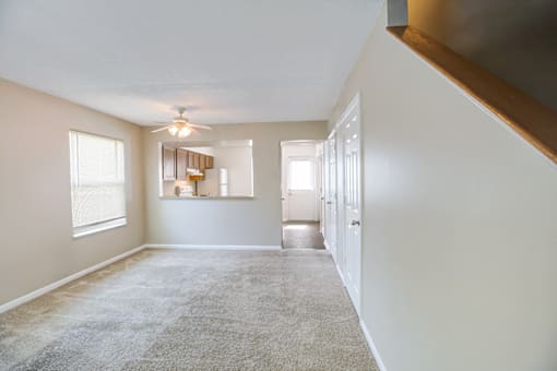 Living room in a 2- or 3-bedroom townhome at Hampton Place Apartments, featuring a spacious layout and natural light.