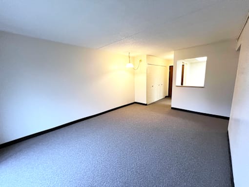 Open living and dining area in a one-bedroom, one-bathroom apartment at Kentwood Square Apartments.