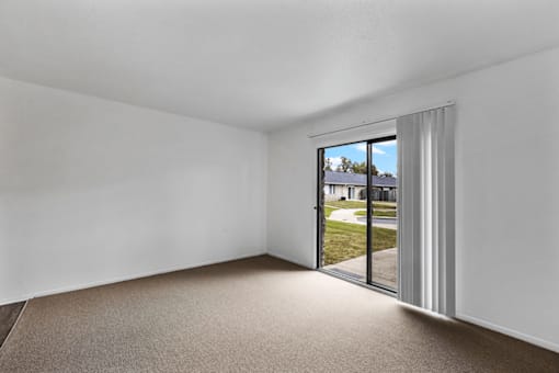 Living room with sliding door to the patio in a 1-bedroom, 1-bathroom apartment at Lebanon Manor Apartments.