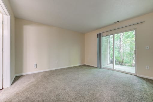 Living room with a sliding glass door to the patio at Brownsburg Pointe.