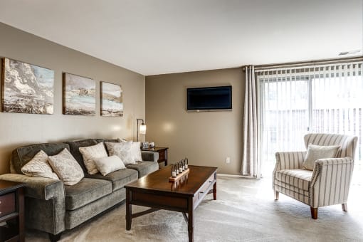 Living space with sliding glass door to balcony or patio at Archer's Pointe.
