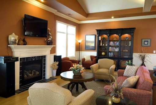 Spacious lounge area at Meredith Meadows Apartments featuring stylish seating and natural lighting.