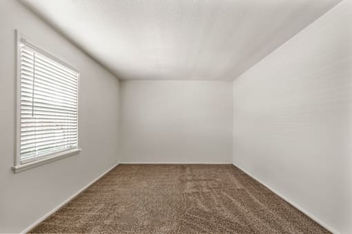 Master bedroom with a window in a 1-bed, 1-bath apartment at Bradford Lake Apartments.
