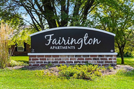 Welcoming monument sign for Fairington Apartments in Anderson, surrounded by greenery.