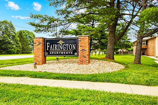 Monument sign for Fairington Apartments in Columbus, Indiana, located at the entrance with landscaped surroundings.