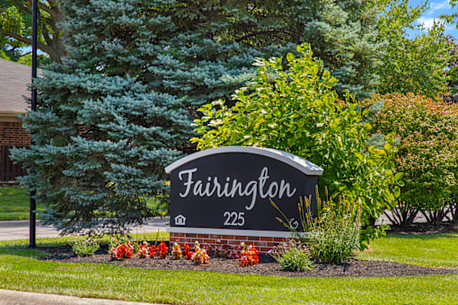 Monument sign for Fairington Apartments in Lafayette, prominently displaying the community name against a landscaped backdrop.